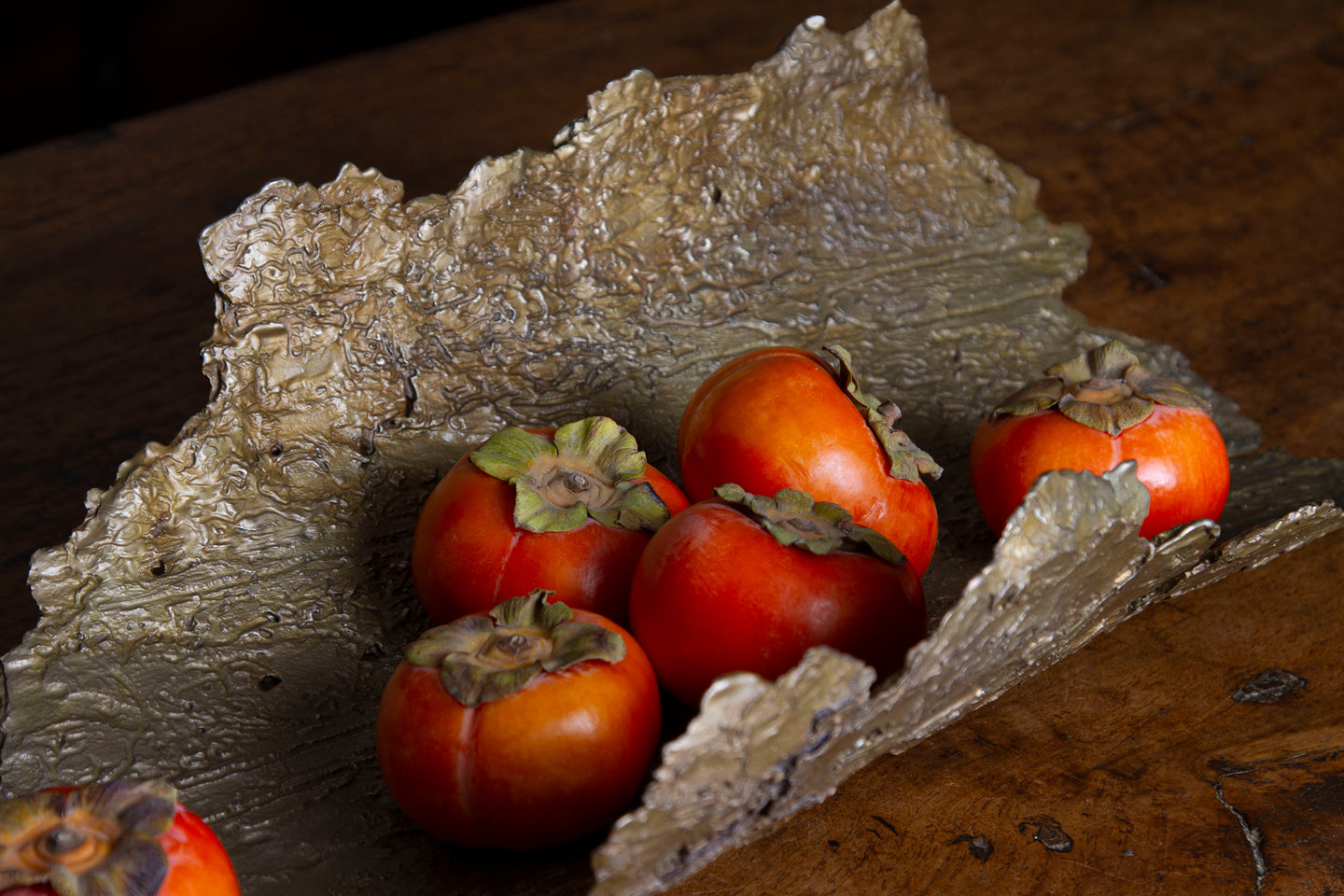 Close-up of the intricate bronze bowl surface, showing flaky bark texture and detailed termite trails.