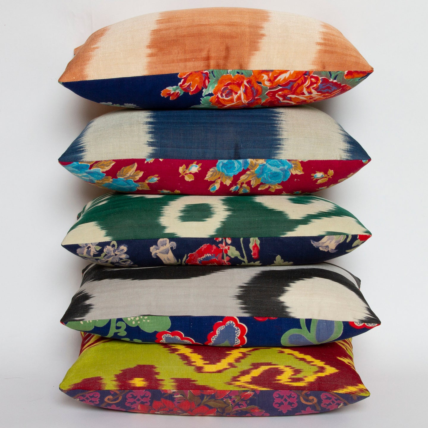 Nina Wildflower Blue ikat pillow with handwoven silk/cotton front and vintage Russian printed cotton back, 10x16 size with other pillows.