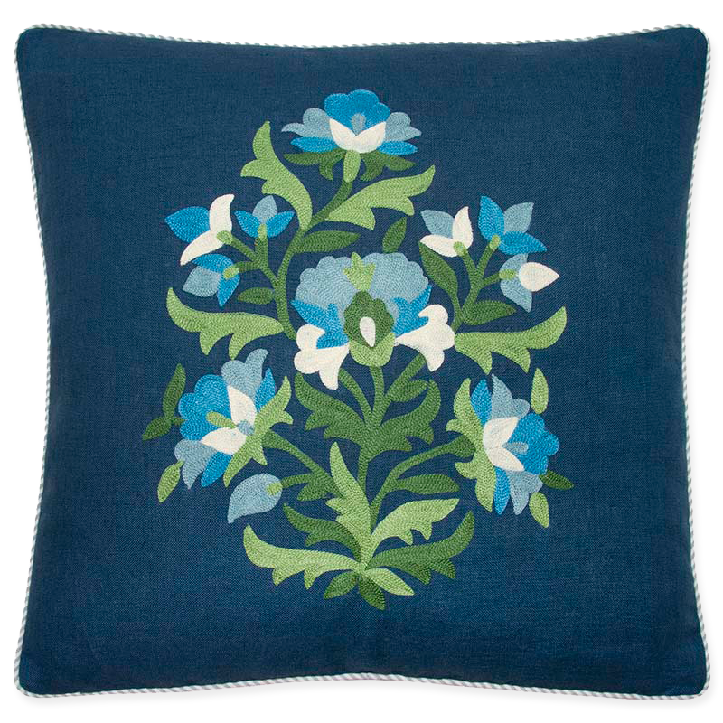 Pillow with vibrant green and blue embroidery on navy linen, bias-cut striped welt in light blue and oyster.