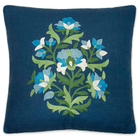 Pillow with vibrant green and blue embroidery on navy linen, bias-cut striped welt in light blue and oyster.