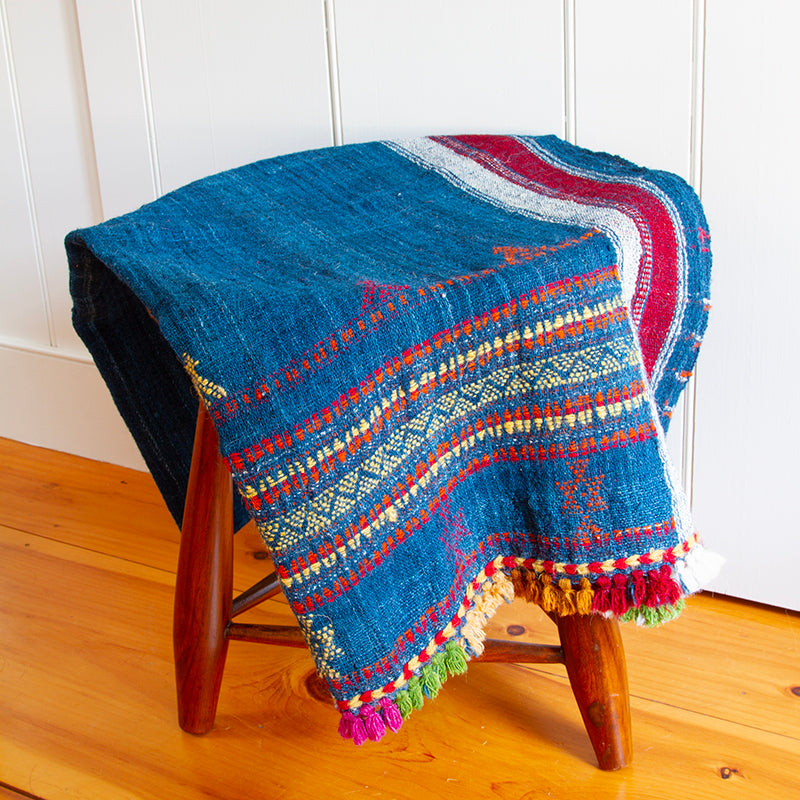 Handwoven wool blanket with multi-colored tassels, 36” x 88”, made from 100% wool, featuring vibrant hand-dyed colors.