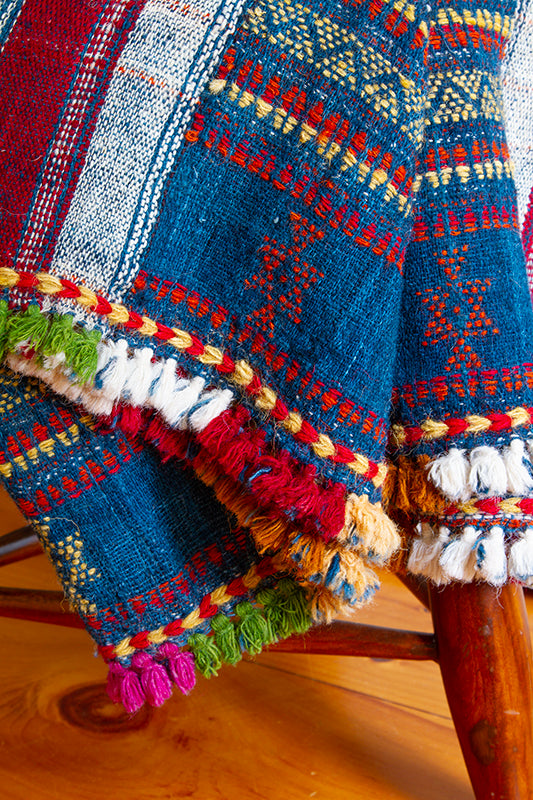 Handwoven wool blanket with multi-colored tassels, 36” x 88”, made from 100% wool, featuring vibrant hand-dyed colors.