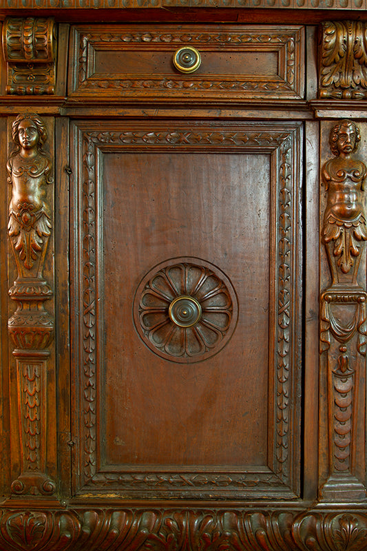 Carving detail on 17th-century Florentine credenza in walnut with intricate carvings, original bronze hardware.