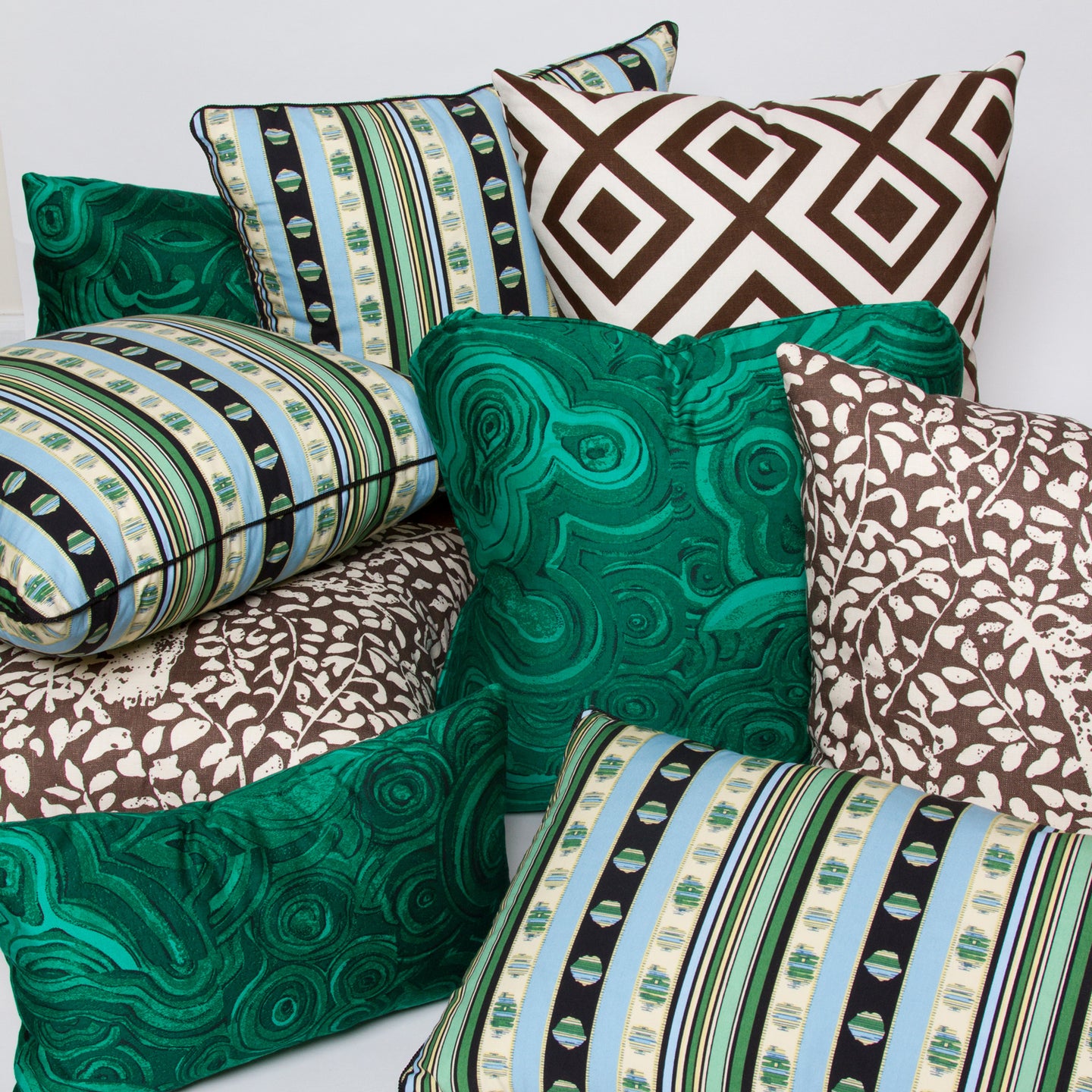 Group of 9 cotton pillows in malachite, matisse, blue and green and black stripe, geometric brown.