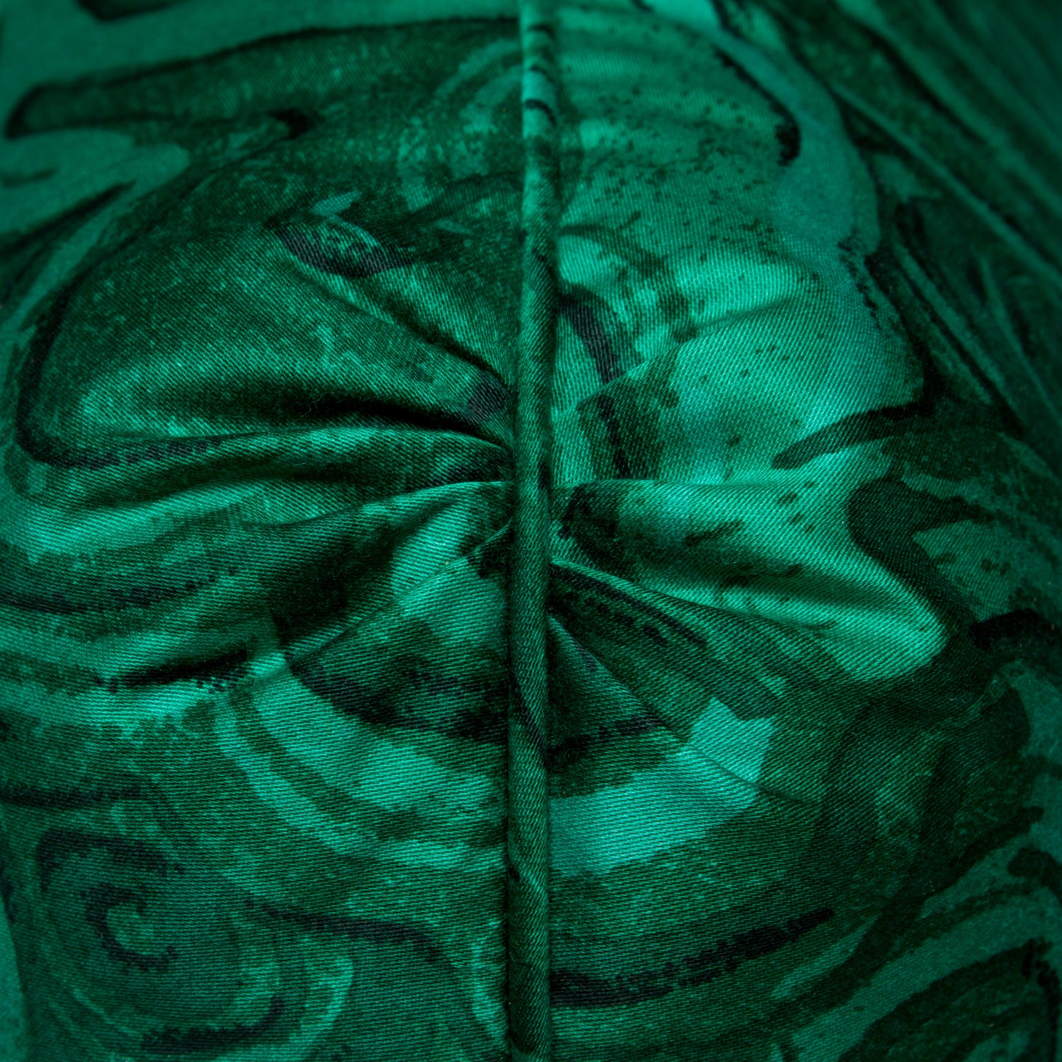 Close-up of the pleated corner detail on the vibrant Gemstone pillow cover in emerald malachite, showcasing the intricate design.