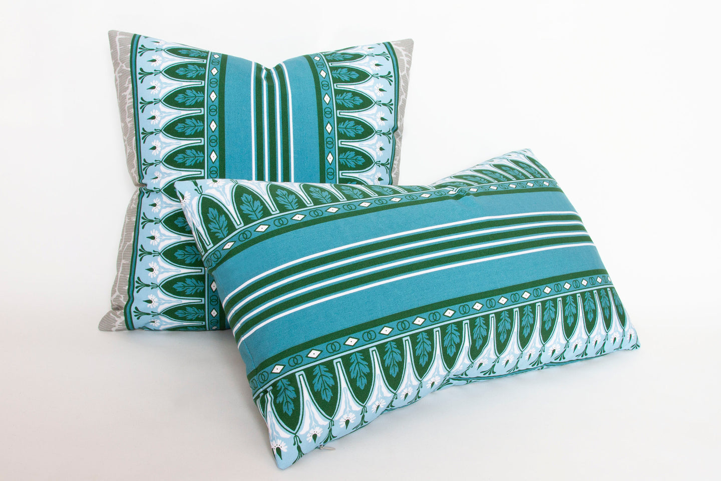 Set of large and small ‘Lola Montez’ Blue Grey pillows, showcasing the intricate stripe and floral patterns in green, blue, and white on cotton percale.