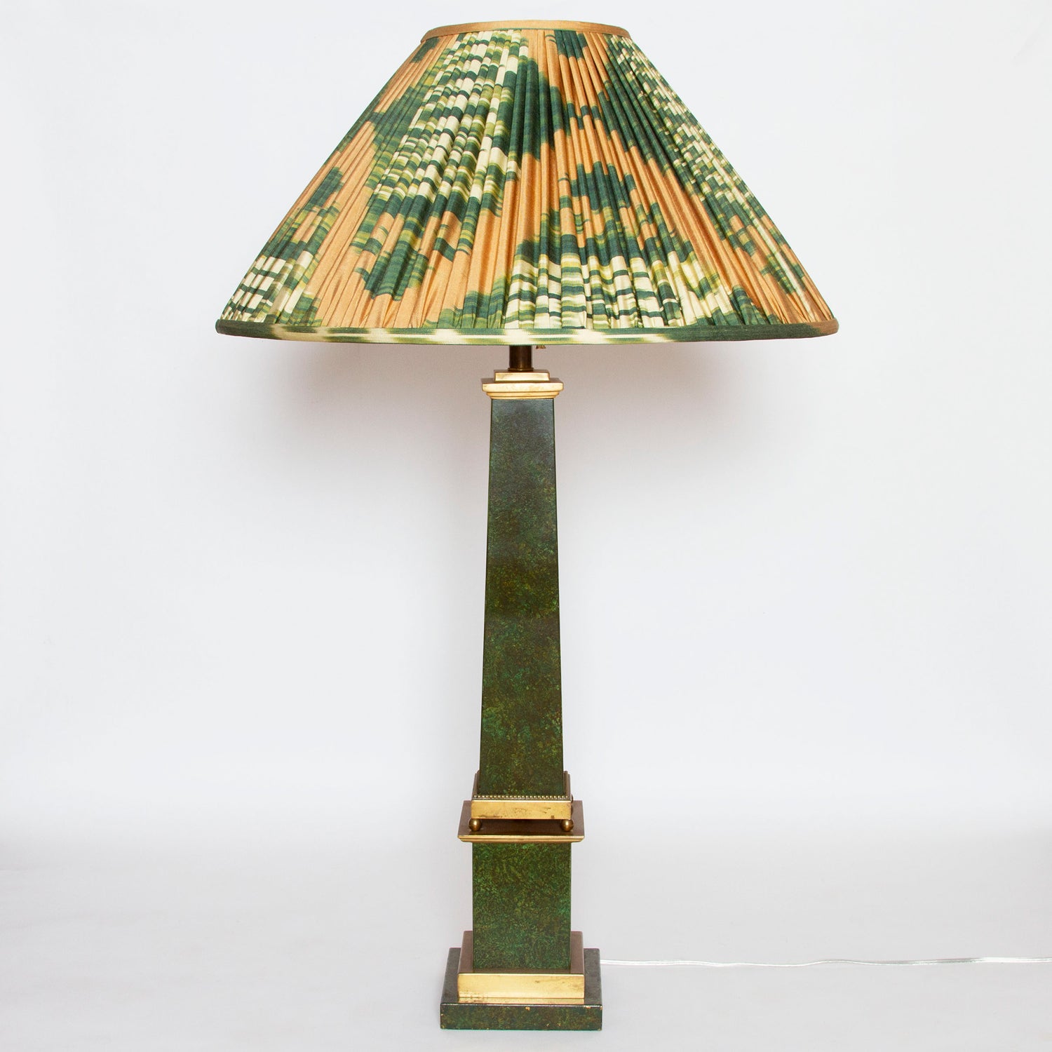 Vintage brass obelisk lamp with faux-marble painted sides, measuring 37” H x 6” W x 6” D.