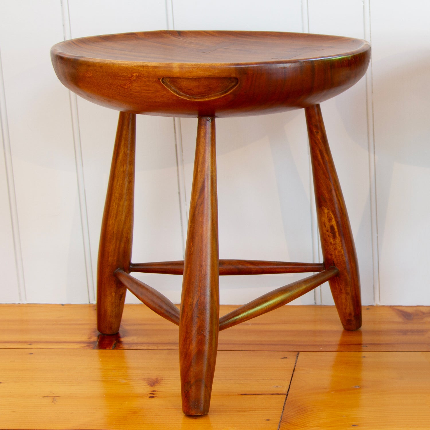 Walnut three-legged stool with carved handles and concave tops.  Used as side tables or seating. 17.5"D x 19" H