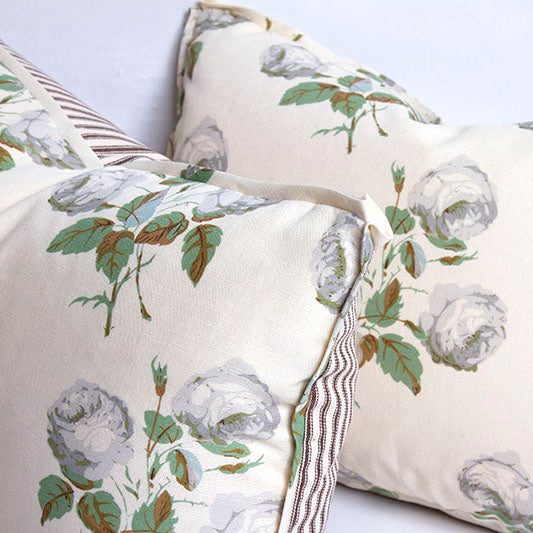 Pillow with Bowood print of gray-white roses and sage leaves; 3/8” flange with butterfly corners; ticking stripe back.