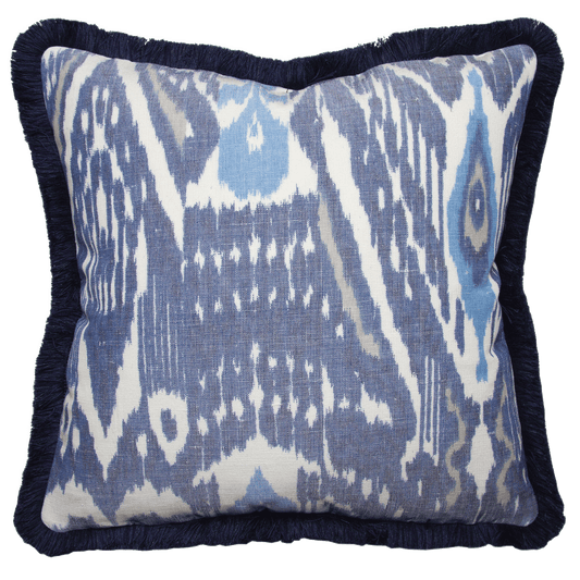 Navy blue, cornflower, clay, and ivory warp-printed ikat pillow with navy fringe, double-sided, 100% cotton-linen blend.