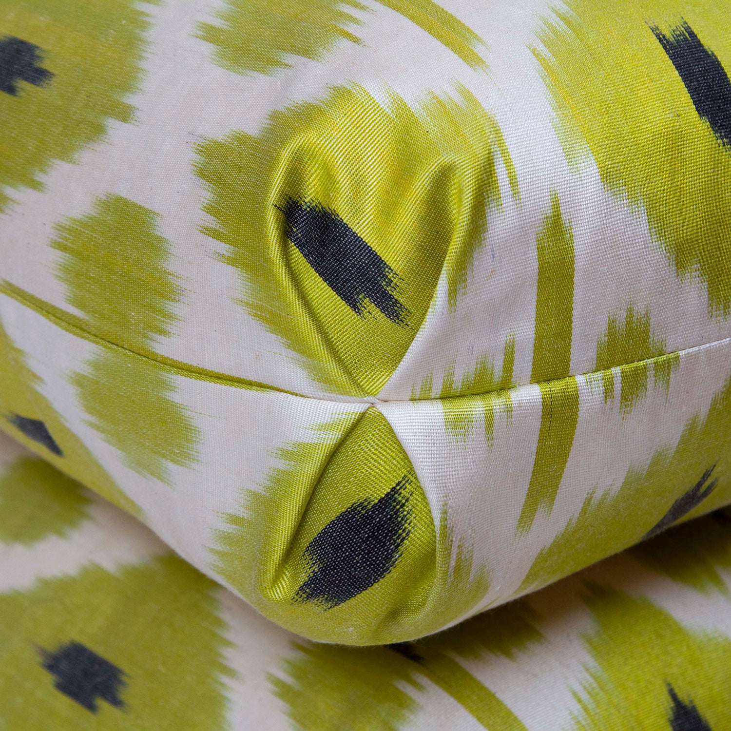 V-pleat Turkish corner detail on handwoven lime silk ikat pillow, 14x18 inches.