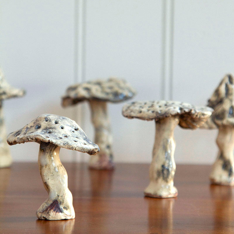 Detailed view of one Hand-sculpted ceramic mushroom in varying sizes, 3 to 5 inches tall, with natural earthy tones.