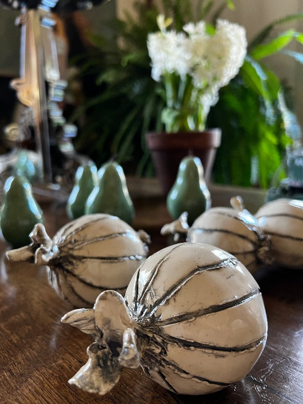 Top detail on hand-sculpted ceramic onions in eggshell and gray glaze, measuring 4 to 6 inches in size.