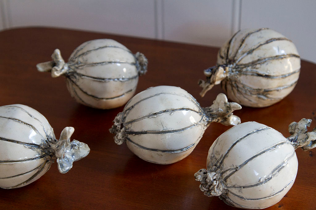 Detail of glaze on hand-sculpted ceramic onions in eggshell and gray glaze, measuring 4 to 6 inches in size.