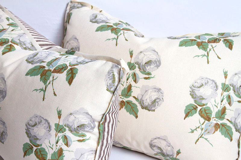 Pillow with Bowood print of gray-white roses and sage leaves; 3/8” flange with butterfly corners; ticking stripe back.