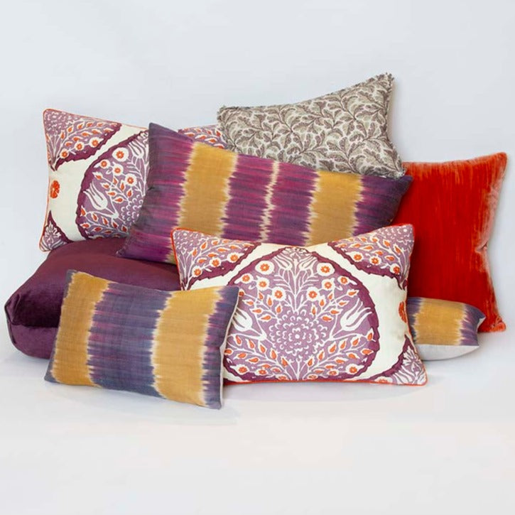 Leaf print Schuyler Samperton pillow, 10” x 16”, in purple and gray tones, trimmed with a 3/8” self-flange with other pillows.