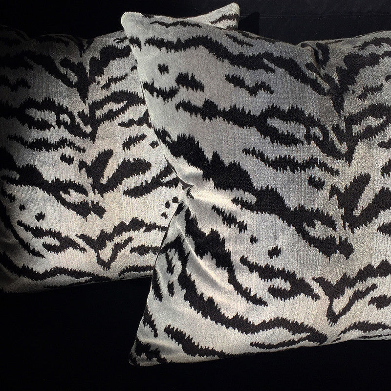 Close-up of two Scalamandre Silver Tiger pillows, highlighting the luxurious silver and gray-blue tiger print with black stripes.