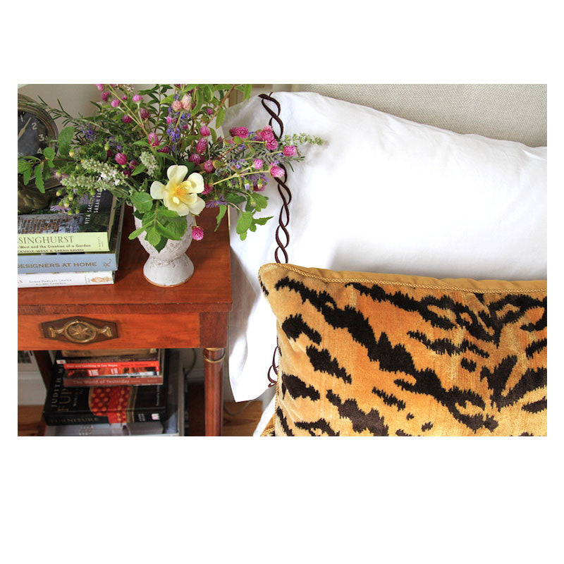 Scalamandre Tigre pillow with tiger print silk velvet front and gold velvet back, elegantly placed on a white bed.