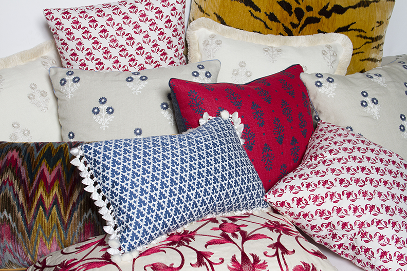 10x16 and 14x24 pillows with indigo flower motif on red linen, indigo cord trim, and backing with other pillows.